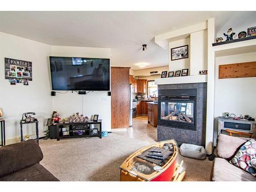 54 Mcdougall, Penhold, AB - Indoor Photo Showing Living Room With Fireplace