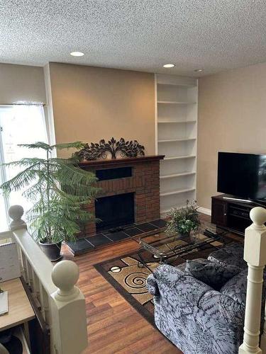 19 Sunhaven Way Se, Calgary, AB - Indoor Photo Showing Living Room With Fireplace