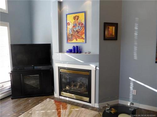 402-4805 45 Street, Red Deer, AB - Indoor Photo Showing Living Room With Fireplace