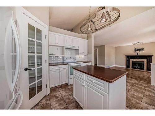 15 Armitage Close, Red Deer, AB - Indoor Photo Showing Kitchen With Fireplace