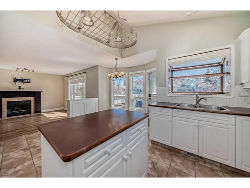 15 Armitage Close, Red Deer, AB - Indoor Photo Showing Kitchen With Fireplace With Double Sink