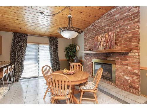 37 Morning Meadows Drive, Rural Ponoka County, AB - Indoor Photo Showing Dining Room With Fireplace