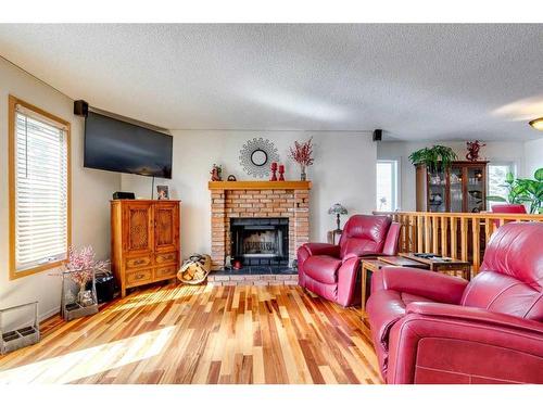 710 Hawkwood Boulevard Nw, Calgary, AB - Indoor Photo Showing Living Room With Fireplace