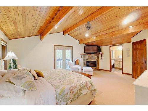 138-36240 Range Road 250, Rural Red Deer County, AB - Indoor Photo Showing Bedroom With Fireplace