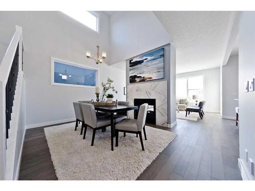 43 Versant View Sw, Calgary, AB - Indoor Photo Showing Dining Room With Fireplace