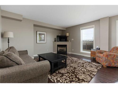 4317 71 Street Close, Camrose, AB - Indoor Photo Showing Living Room With Fireplace