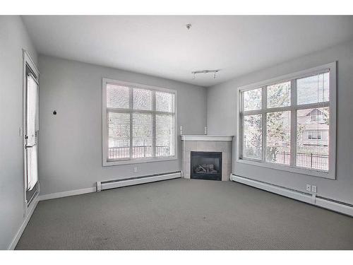 101-100 Lakeway, Sylvan Lake, AB - Indoor Photo Showing Other Room With Fireplace