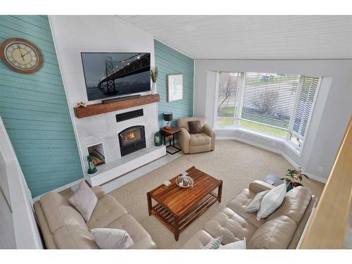 32 Newlands Avenue, Red Deer, AB - Indoor Photo Showing Living Room With Fireplace