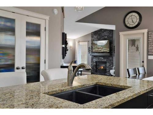 79 Voisin Close, Red Deer, AB - Indoor Photo Showing Kitchen With Fireplace With Double Sink