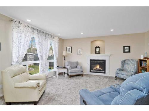 101 Old Boomer Road, Sylvan Lake, AB - Indoor Photo Showing Living Room With Fireplace