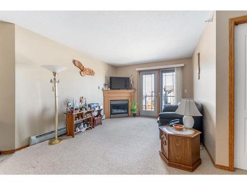 217-260 Duston Street, Red Deer, AB - Indoor Photo Showing Living Room With Fireplace