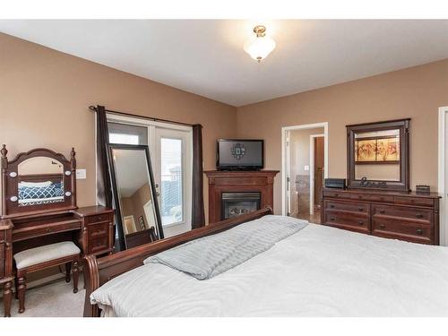12 Valentine Crescent, Red Deer, AB - Indoor Photo Showing Bedroom With Fireplace