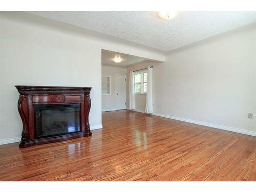 4624 49 Street, Red Deer, AB - Indoor Photo Showing Living Room With Fireplace
