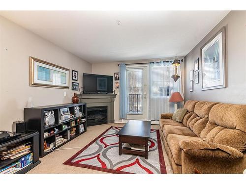 106-3730 50 Avenue, Red Deer, AB - Indoor Photo Showing Living Room With Fireplace