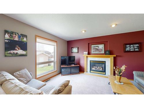 4102 66 Street, Stettler, AB - Indoor Photo Showing Living Room With Fireplace