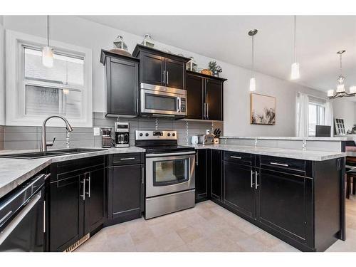 70 Harvest Close, Penhold, AB - Indoor Photo Showing Kitchen With Stainless Steel Kitchen With Upgraded Kitchen