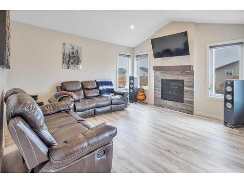 57 Mackenzie Avenue, Lacombe, AB - Indoor Photo Showing Living Room With Fireplace