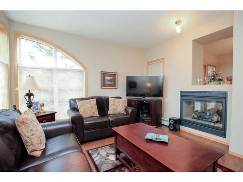211-5300 48 Street, Red Deer, AB - Indoor Photo Showing Living Room With Fireplace