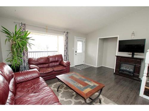 5616 52 Street Close, Eckville, AB - Indoor Photo Showing Living Room With Fireplace