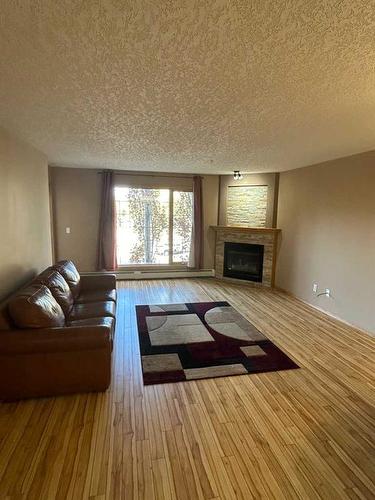 212-4805 45 Street, Red Deer, AB - Indoor Photo Showing Living Room With Fireplace