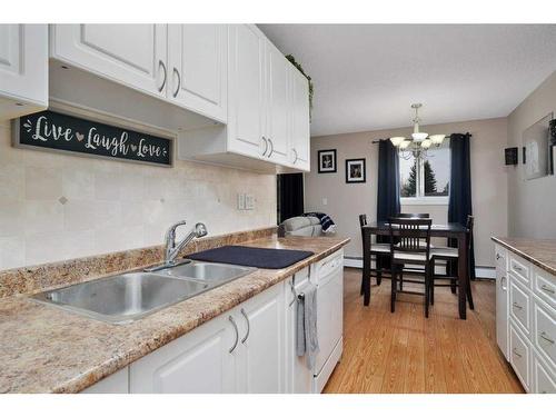 205-25 Robinson Avenue, Penhold, AB - Indoor Photo Showing Kitchen With Double Sink