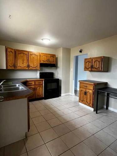 3715 50 Street, Red Deer, AB - Indoor Photo Showing Kitchen With Double Sink