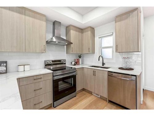 885-903 Mahogany Boulevard Se, Calgary, AB - Indoor Photo Showing Kitchen With Double Sink