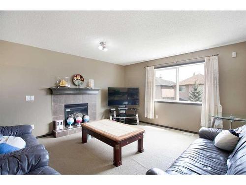 1068 Sherwood Boulevard Nw, Calgary, AB - Indoor Photo Showing Living Room With Fireplace