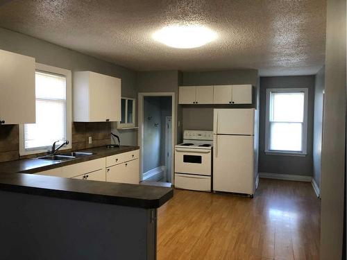 4635 49 Street, Sylvan Lake, AB - Indoor Photo Showing Kitchen With Double Sink