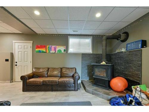 182 Sabre Road, Springbrook, AB - Indoor With Fireplace