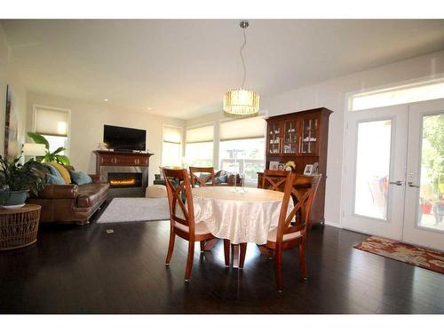 69 Grove Close, Red Deer, AB - Indoor Photo Showing Dining Room With Fireplace