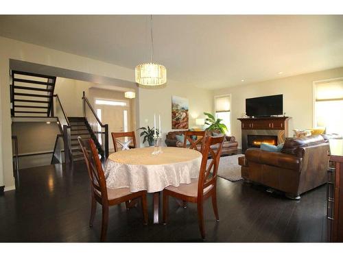 69 Grove Close, Red Deer, AB - Indoor Photo Showing Dining Room With Fireplace