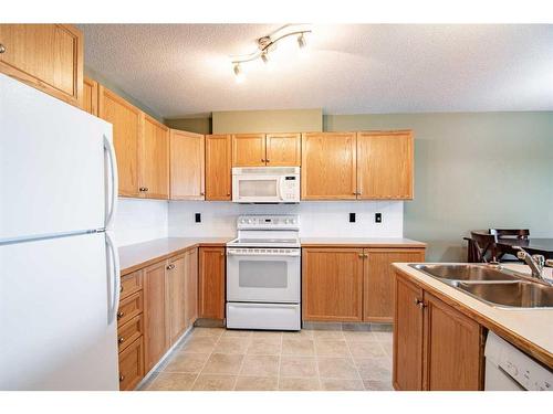 129-260 Duston Street, Red Deer, AB - Indoor Photo Showing Kitchen With Double Sink