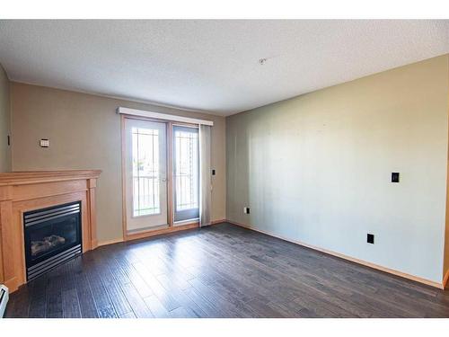 129-260 Duston Street, Red Deer, AB - Indoor With Fireplace