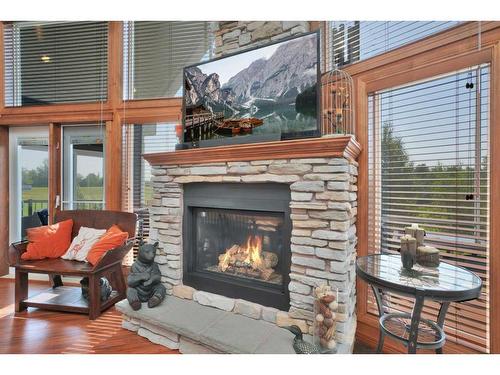 4030-25054 South Pine Lake Road, Rural Red Deer County, AB - Indoor Photo Showing Living Room With Fireplace