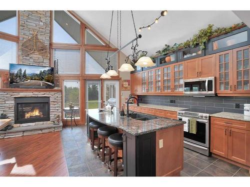 4030-25054 South Pine Lake Road, Rural Red Deer County, AB - Indoor Photo Showing Kitchen With Fireplace With Double Sink