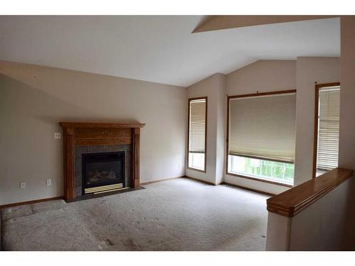 4204 55 Avenue Crescent, Innisfail, AB - Indoor Photo Showing Living Room With Fireplace