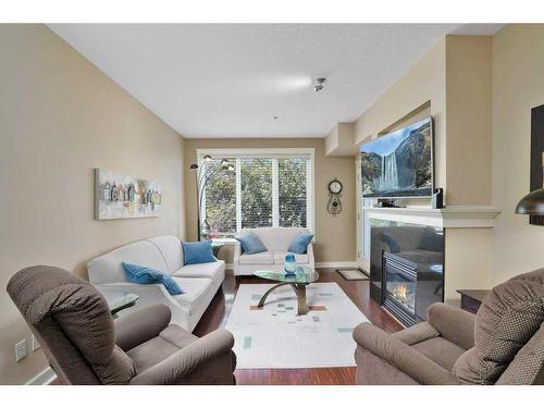 204-4707 50 Street, Sylvan Lake, AB - Indoor Photo Showing Living Room With Fireplace