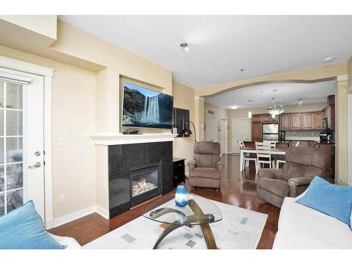 204-4707 50 Street, Sylvan Lake, AB - Indoor Photo Showing Living Room With Fireplace