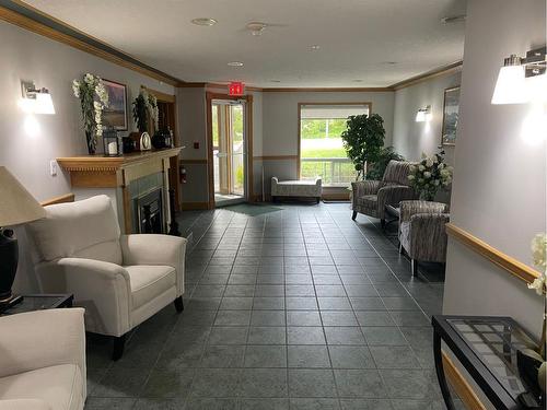 206-4625 50 Street, Camrose, AB - Indoor Photo Showing Living Room With Fireplace