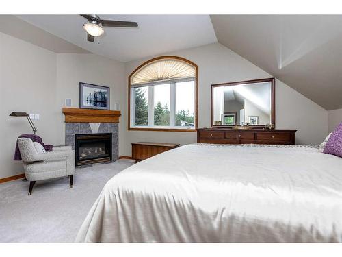 120-37411 Waskasoo Avenue, Rural Red Deer County, AB - Indoor Photo Showing Bedroom With Fireplace