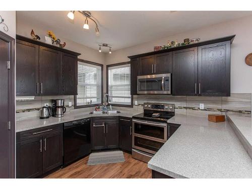 10 Iron Wolf Close, Lacombe, AB - Indoor Photo Showing Kitchen With Double Sink