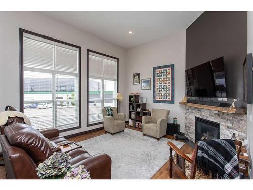 10 Iron Wolf Close, Lacombe, AB - Indoor Photo Showing Living Room With Fireplace