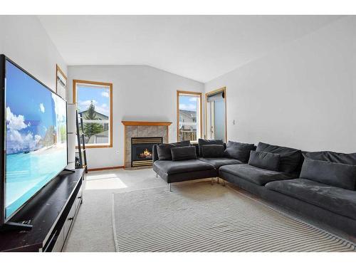 58 Old Boomer Road, Sylvan Lake, AB - Indoor Photo Showing Living Room With Fireplace