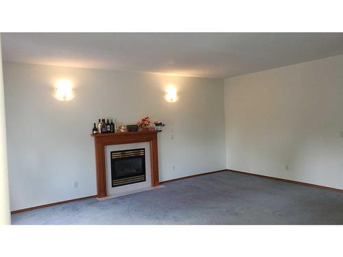 43 Ackerman Crescent, Red Deer, AB - Indoor Photo Showing Living Room With Fireplace