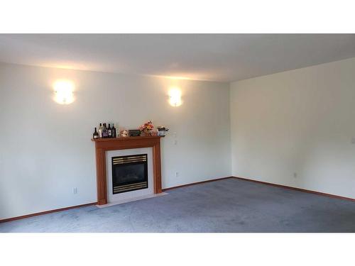 43 Ackerman Crescent, Red Deer, AB - Indoor Photo Showing Living Room With Fireplace