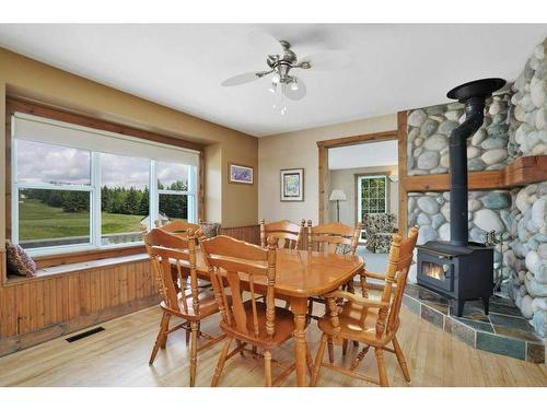 26 Sunnyside Drive, Rural Ponoka County, AB - Indoor Photo Showing Dining Room With Fireplace