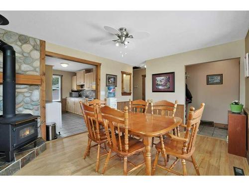 26 Sunnyside Drive, Rural Ponoka County, AB - Indoor Photo Showing Dining Room With Fireplace