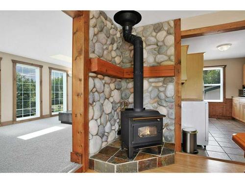 26 Sunnyside Drive, Rural Ponoka County, AB - Indoor Photo Showing Living Room With Fireplace