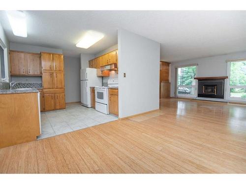 3 Macleod Close, Red Deer, AB - Indoor Photo Showing Kitchen With Fireplace